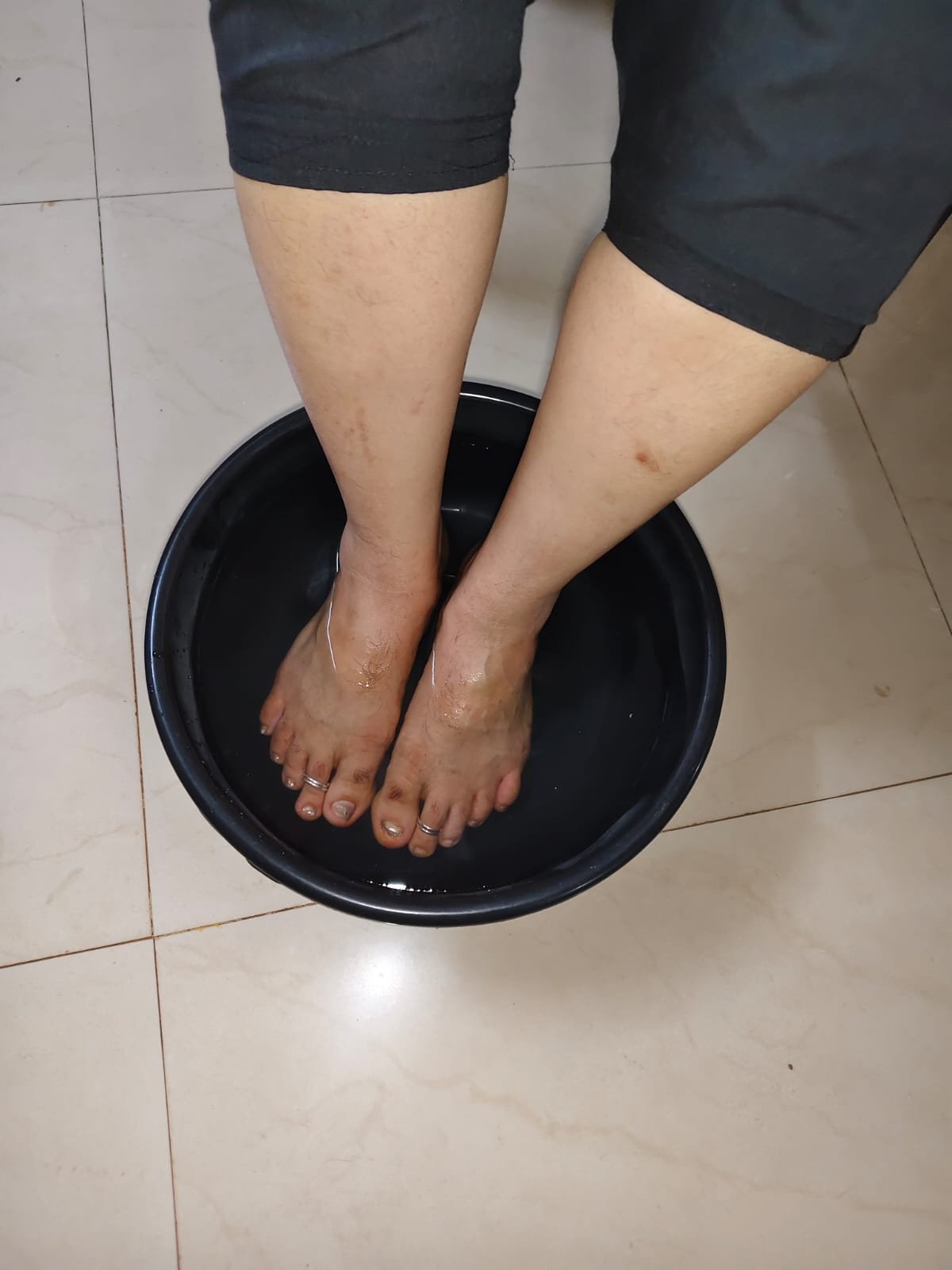 Client using a vibration and foot massage station at the studio